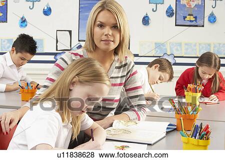 Group Of Primary Schoolchildren And Teacher Having lesson In Classroom View Large Photo Image Stock Photo - Group Of Primary Schoolchildren And Teacher Having lesson In Classroom. Fotosearch
