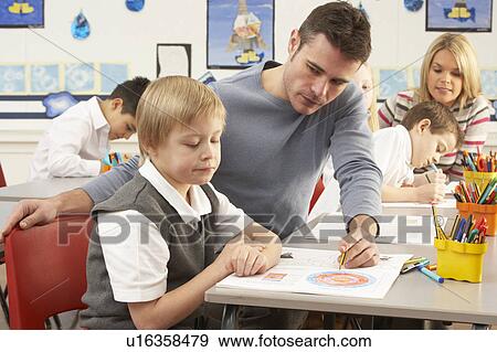 Group Of Primary Schoolchildren And Teacher Having lesson In Classroom View Large Photo Image Stock Photo - Group Of Primary Schoolchildren And Teacher Having lesson In Classroom. Fotosearch