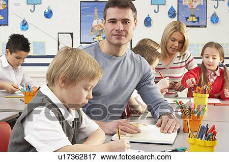 Group Of Primary Schoolchildren And Teacher Having lesson In Classroom View Large Photo Image Stock Photo - Group Of Primary Schoolchildren And Teacher Having lesson In Classroom. Fotosearch