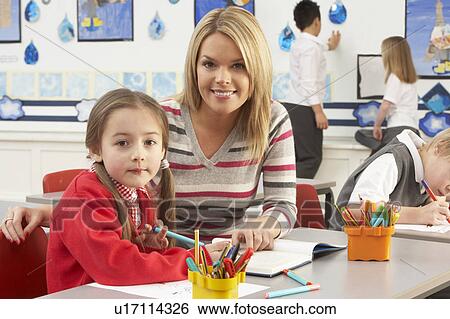 Group Of Primary Schoolchildren And Teacher Having lesson In Classroom View Large Photo Image Stock Photograph - Group Of Primary Schoolchildren And Teacher Having lesson In Classroom. Fotosearch