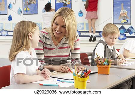 Group Of Primary Schoolchildren And Teacher Having lesson In Classroom View Large Photo Image Stock Photograph - Group Of Primary Schoolchildren And Teacher Having lesson In Classroom. Fotosearch