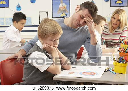 Stock Photography - Group Of Primary Schoolchildren And Teacher Having lesson In Classroom. Fotosearch