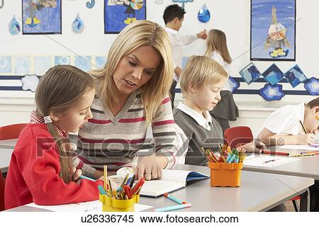 Group Of Primary Schoolchildren And Teacher Having lesson In Classroom View Large Photo Image Stock Photography - Group Of Primary Schoolchildren And Teacher Having lesson In Classroom. Fotosearch
