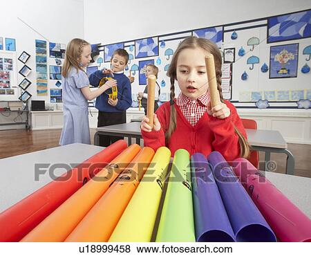 Group Of Primary Schoolchildren Having Music Lesson In Classroom View Large Photo Image Stock Photo - Group Of Primary Schoolchildren Having Music Lesson In Classroom. Fotosearch