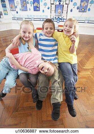 Group Of Primary Schoolchildren In Classroom View Large Photo Image Stock Photo - Group Of Primary Schoolchildren In Classroom. Fotosearch