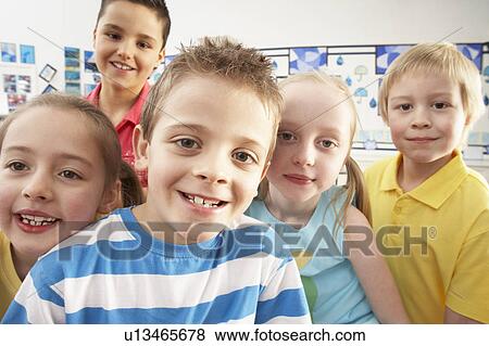 Stock Photo - Group Of Primary Schoolchildren In Classroom. Fotosearch