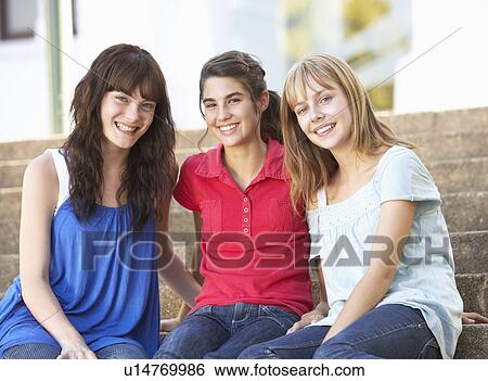Stock Photograph - Group Of Teenage Female Friends Sitting On College Steps Outside. Fotosearch