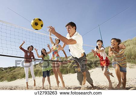 Group Of Teenage Friends Playing Volleyball On Beach View Large Photo Image Stock Image - Group Of Teenage Friends Playing Volleyball On Beach. Fotosearch