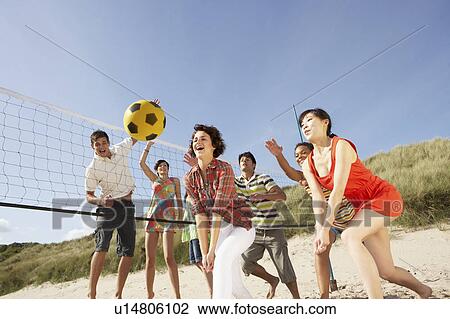 Group Of Teenage Friends Playing Volleyball On Beach View Large Photo Image Stock Image - Group Of Teenage Friends Playing Volleyball On Beach. Fotosearch