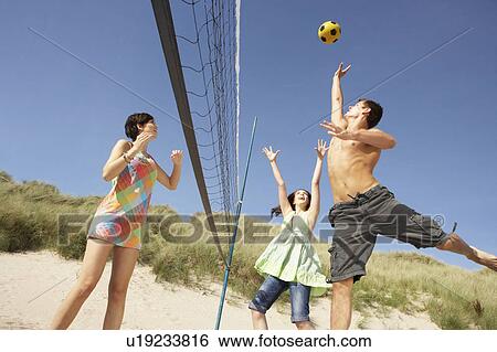 Group Of Teenage Friends Playing Volleyball On Beach View Large Photo Image Stock Photograph - Group Of Teenage Friends Playing Volleyball On Beach. Fotosearch