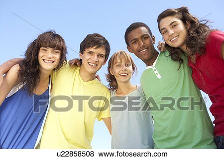 Group Of Teenage Friends Standing Outside View Large Photo Image Stock Photo - Group Of Teenage Friends Standing Outside. Fotosearch
