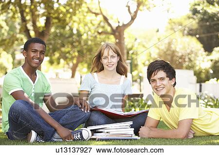 Group Of Teenage Students Chatting Together In Park View Large Photo Image Stock Photo - Group Of Teenage Students Chatting Together In Park. Fotosearch