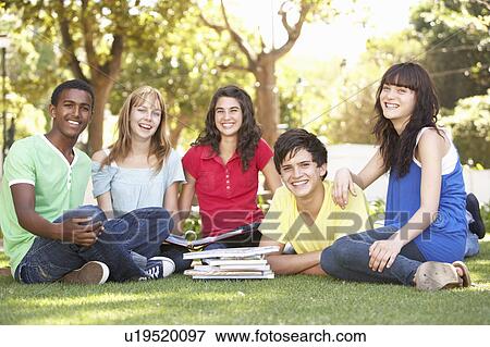 Stock Photo - Group Of Teenage Students Chatting Together In Park. Fotosearch