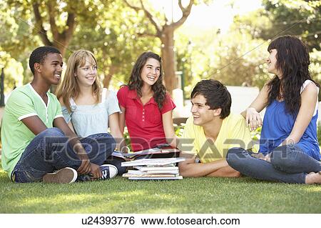 Stock Photograph - Group Of Teenage Students Chatting Together In Park. Fotosearch