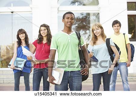Stock Image - Group Of Teenage Students Standing Outside College Building. Fotosearch
