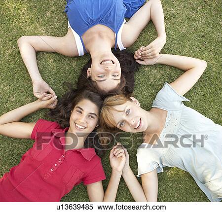 Stock Photography - Group Of Teenager Girls Looking Up Into Camera. Fotosearch