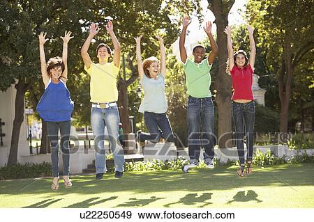 Group Of Teenagers Jumping In Air In Park View Large Photo Image Stock Photo - Group Of Teenagers Jumping In Air In Park. Fotosearch