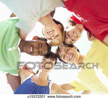 Stock Image - Group Of Teenagers Looking Down Into Camera. Fotosearch