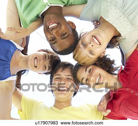 Stock Image - Group Of Teenagers Looking Down Into Camera. Fotosearch