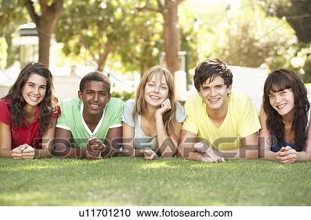 Group Of Teenagers Lying On Stomachs In Park View Large Photo Image Stock Image - Group Of Teenagers Lying On Stomachs In Park. Fotosearch