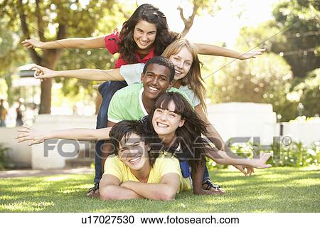 Group Of Teenagers Piled Up In Park View Large Photo Image Stock Image - Group Of Teenagers Piled Up In Park. Fotosearch