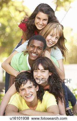 Group Of Teenagers Piled Up In Park View Large Photo Image Stock Photo - Group Of Teenagers Piled Up In Park. Fotosearch