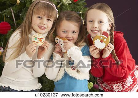 Group Of Young Children With Presents In Front Of Christmas Tree View Large Photo Image Stock Photo - Group Of Young Children With Presents In Front Of Christmas Tree. Fotosearch