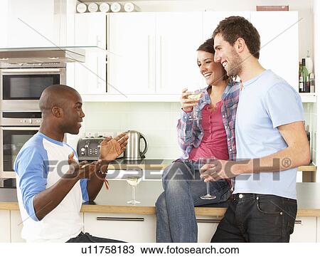 Group Of Young Friends Enjoying Glass Of Wine In Modern Kitchen View Large Photo Image Stock Image - Group Of Young Friends Enjoying Glass Of Wine In Modern Kitchen. Fotosearch