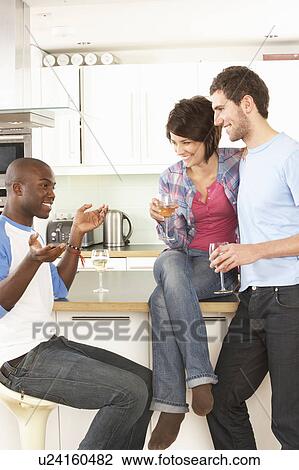 Group Of Young Friends Enjoying Glass Of Wine In Modern Kitchen View Large Photo Image Stock Image - Group Of Young Friends Enjoying Glass Of Wine In Modern Kitchen. Fotosearch