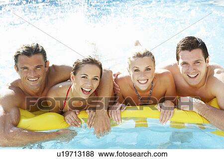 Group of Young friends having fun in pool View Large Photo Image Stock Photo - Group of Young friends having fun in pool. Fotosearch