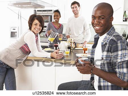 Group Of Young Friends Preparing Breakfast In Modern Kitchen View Large Photo Image Picture - Group Of Young Friends Preparing Breakfast In Modern Kitchen. Fotosearch