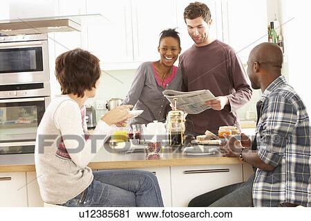 Group Of Young Friends Preparing Breakfast In Modern Kitchen View Large Photo Image Stock Image - Group Of Young Friends Preparing Breakfast In Modern Kitchen. Fotosearch
