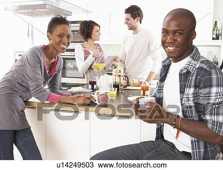 Group Of Young Friends Preparing Breakfast In Modern Kitchen View Large Photo Image Stock Image - Group Of Young Friends Preparing Breakfast In Modern Kitchen. Fotosearch