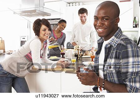 Group Of Young Friends Preparing Breakfast In Modern Kitchen View Large Photo Image Stock Photo - Group Of Young Friends Preparing Breakfast In Modern Kitchen. Fotosearch