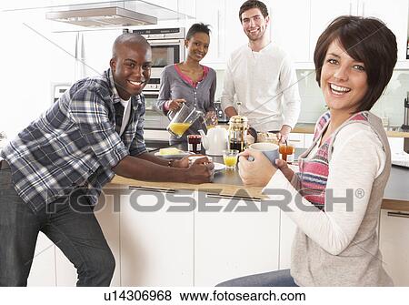 Group Of Young Friends Preparing Breakfast In Modern Kitchen View Large Photo Image Stock Photo - Group Of Young Friends Preparing Breakfast In Modern Kitchen. Fotosearch