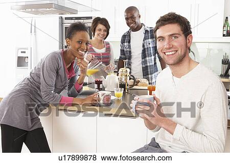 Group Of Young Friends Preparing Breakfast In Modern Kitchen View Large Photo Image Stock Photo - Group Of Young Friends Preparing Breakfast In Modern Kitchen. Fotosearch