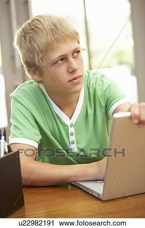 Guilty Looking Teenage Boy Using Laptop At Home View Large Photo Image Stock Image - Guilty Looking Teenage Boy Using Laptop At Home. Fotosearch