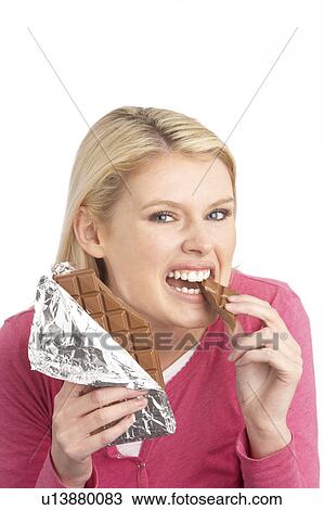 Guilty Looking Young Woman Eating Big Bar Of Chocolate In Studio View Large Photo Image Stock Image - Guilty Looking Young Woman Eating Big Bar Of Chocolate In Studio. Fotosearch