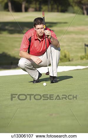 Male Golfer On Golf Course Lining Up Putt On Green View Large Photo Image Stock Photo - Male Golfer On Golf Course Lining Up Putt On Green. Fotosearch