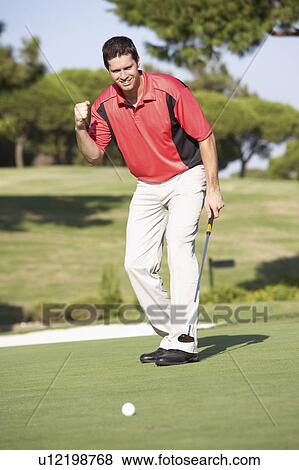 Stock Photo - Male Golfer On Golf Course Putting On Green. Fotosearch