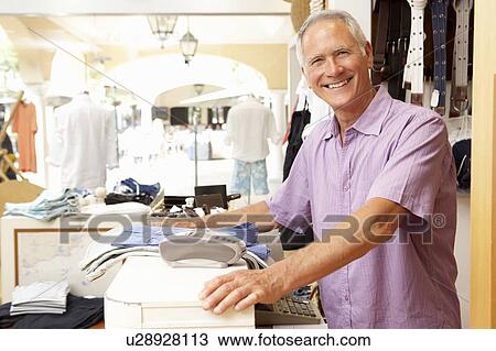 Male Sales Assistant At Checkout Of Clothing Store View Large Photo Image Stock Image - Male Sales Assistant At Checkout Of Clothing Store. Fotosearch