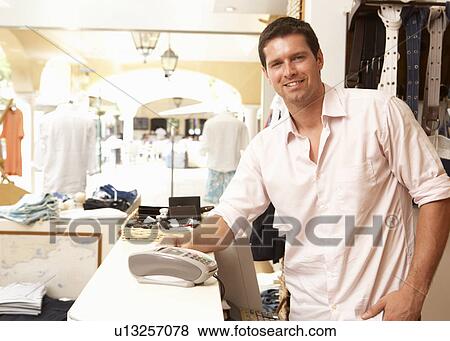 Male Sales Assistant At Checkout Of Clothing Store View Large Photo Image Stock Photo - Male Sales Assistant At Checkout Of Clothing Store. Fotosearch