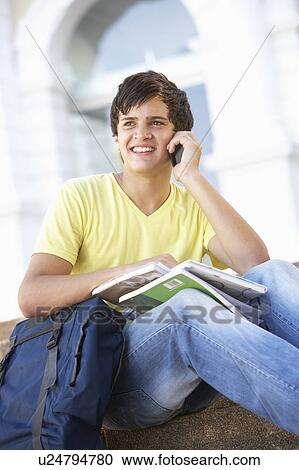 Male Teenage Student Sitting Outside On College Steps Using Mobile Phone View Large Photo Image Stock Image - Male Teenage Student Sitting Outside On College Steps Using Mobile Phone. Fotosearch