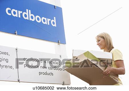 Stock Image - Man At Recycling Centre Disposing Of Cardboard. Fotosearch