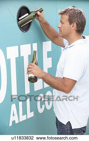 Man At Recycling Centre Disposing Of Glass At Bottle Bank View Large Photo Image Stock Image - Man At Recycling Centre Disposing Of Glass At Bottle Bank. Fotosearch