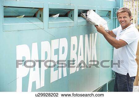 Man At Recycling Centre Disposing Of Old Newspapers View Large Photo Image Stock Image - Man At Recycling Centre Disposing Of Old Newspapers. Fotosearch