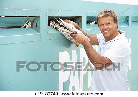 Man At Recycling Centre Disposing Of Old Newspapers View Large Photo Image Stock Photo - Man At Recycling Centre Disposing Of Old Newspapers. Fotosearch