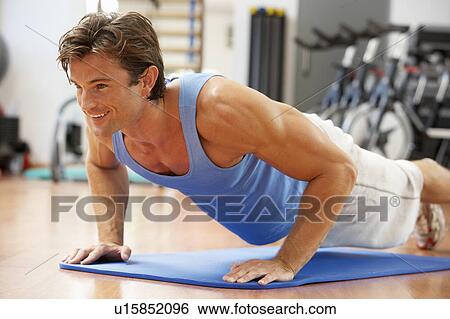 Stock Photograph - Man Doing Press Ups In Gym. Fotosearch