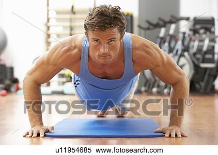 Stock Photography - Man Doing Press Ups In Gym. Fotosearch