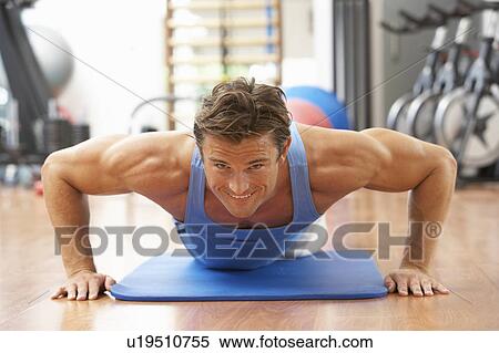 Stock Photography - Man Doing Press Ups In Gym. Fotosearch